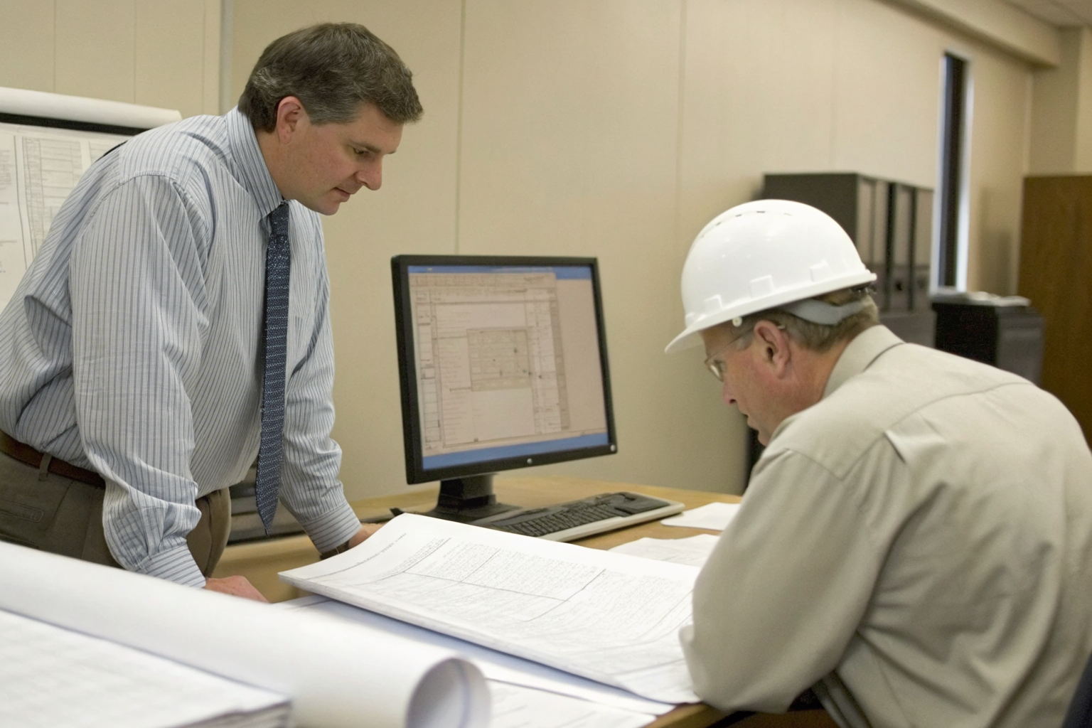 DEP official reviewing septic system applications in an office.