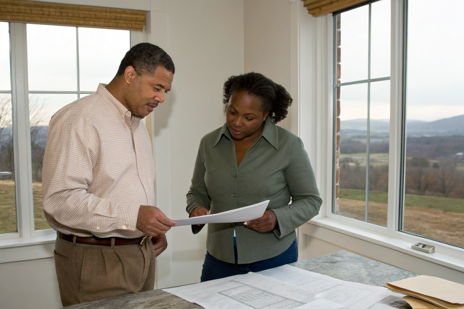 Homeowner and VDH representative discussing permit requirements indoors.